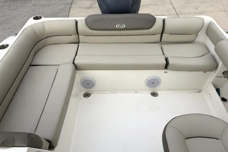 Slide: The Image of 2024 Key West 239 DFS boat interior with beige seating and cup holders. - 28