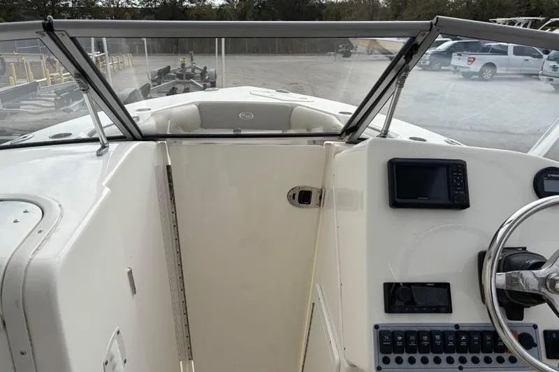 Slide: The Image of 2024 Key West 239 DFS boat interior with steering wheel and control panel. - 15