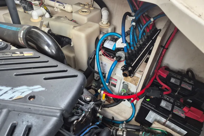 Slide: The Image of Engine compartment of a 2005 Sea Ray 340 Sundancer with visible wiring and batteries. - 27