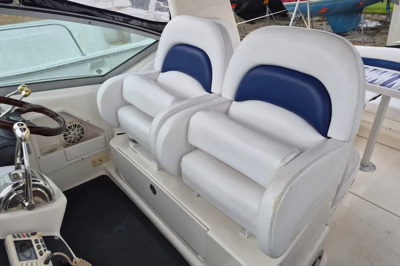 Slide: The Image of 2005 Sea Ray 340 Sundancer helm with dual white and blue captain seats. - 10