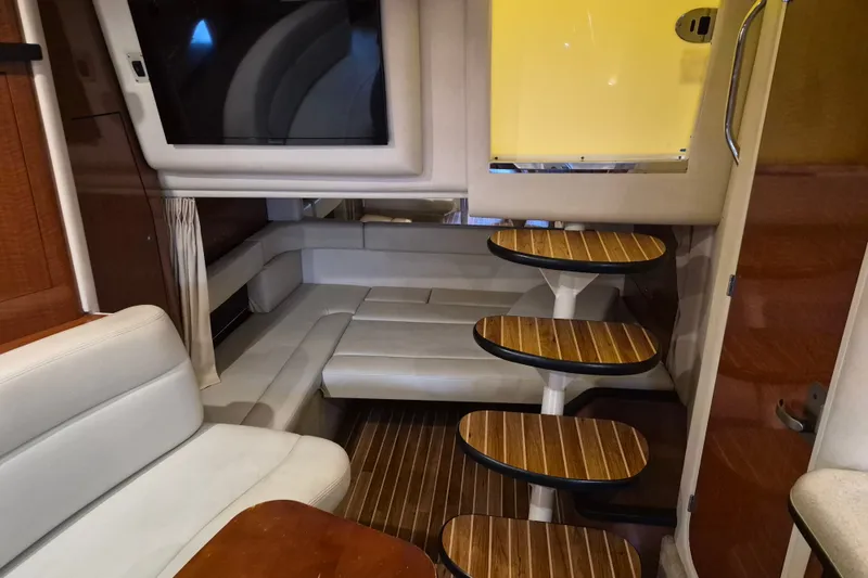 Slide: The Image of Interior of 2005 Sea Ray 340 Sundancer yacht with elegant seating and wooden steps. - 14