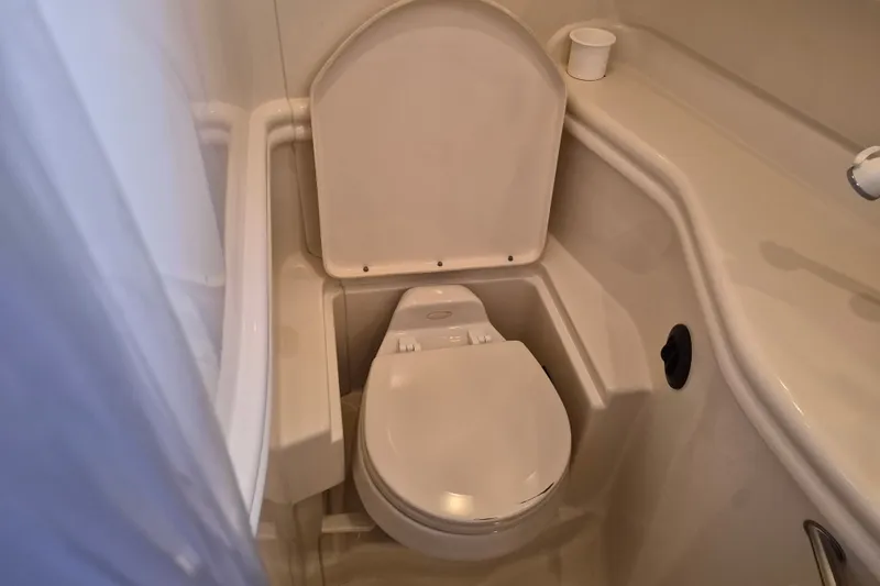 Slide: The Image of Bathroom of 2005 Sea Ray 340 Sundancer yacht, featuring compact marine toilet. - 21