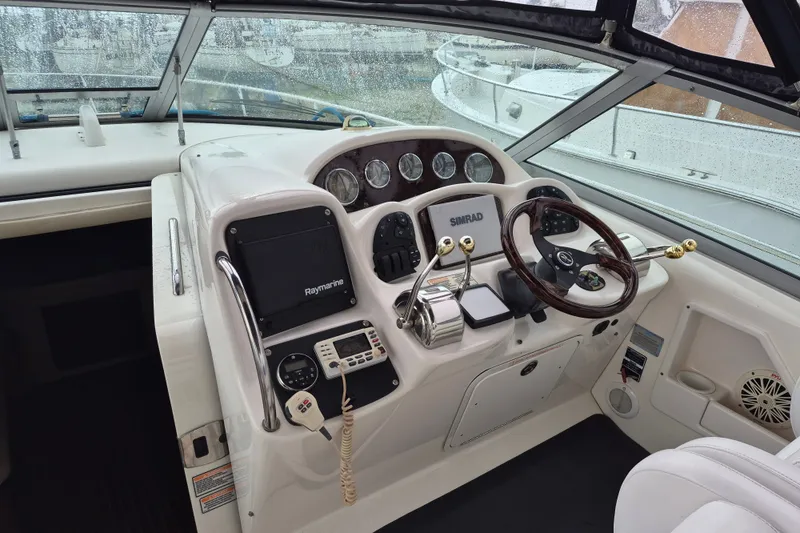 Slide: The Image of Helm of 2005 Sea Ray 340 Sundancer with navigation equipment and steering wheel. - 8