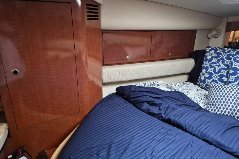 Slide: The Image of Interior cabin of 2005 Sea Ray 340 Sundancer with wood cabinetry and cozy bedding. - 20