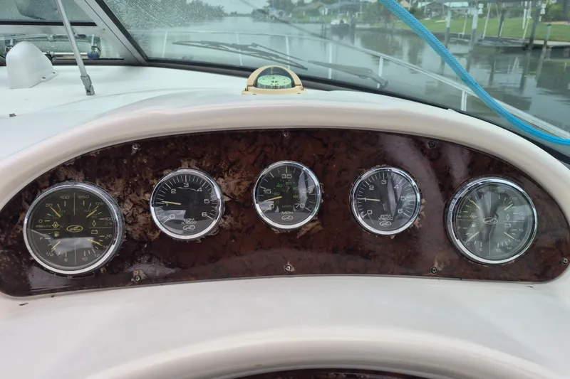 Slide: The Image of Dashboard of a 2005 Sea Ray 340 Sundancer boat with gauges and compass. - 6