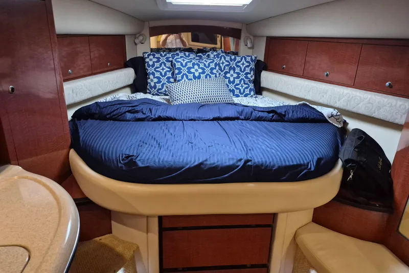 Slide: The Image of Luxurious cabin interior of 2005 Sea Ray 340 Sundancer with cozy bedding and wood accents. - 18