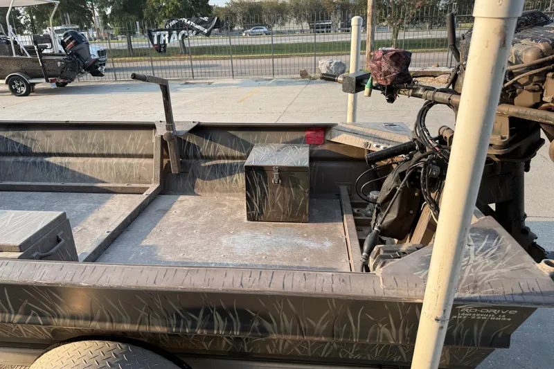 Slide: The Image of 2015 Custom Pro Drive 1754 boat with camouflage design and motor, parked outdoors. - 10