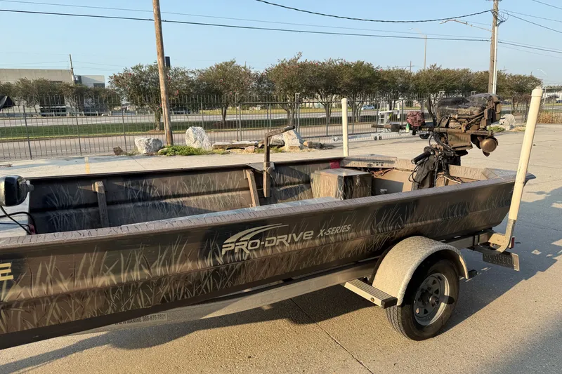 Slide: The Image of 2015 Custom Pro Drive 1754 boat on trailer, parked outdoors. - 8