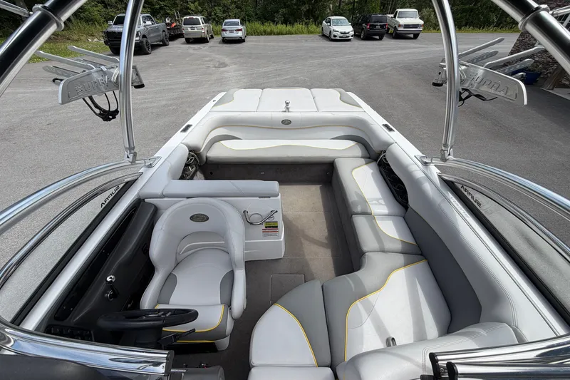 Slide: The Image of 2008 Supra Launch 22 SSV boat interior with white and gray seating, parked outdoors. - 15