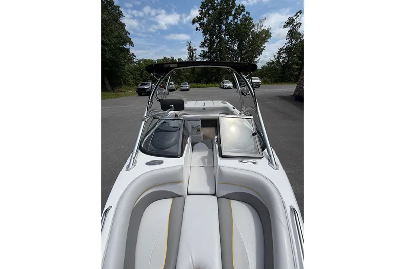 Slide: The Image of 2008 Supra Launch 22 SSV boat interior with seating and windshield, parked outdoors. - 13