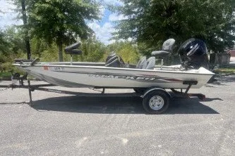 The Image of 2023 Tracker Pro Team 175 TXW boat on trailer, parked outdoors. - 0