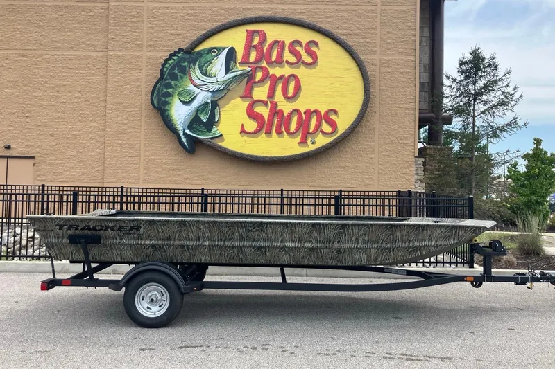 The Image of 2026 Tracker Grizzly 1860 Utility boat on trailer outside Bass Pro Shops. - 0