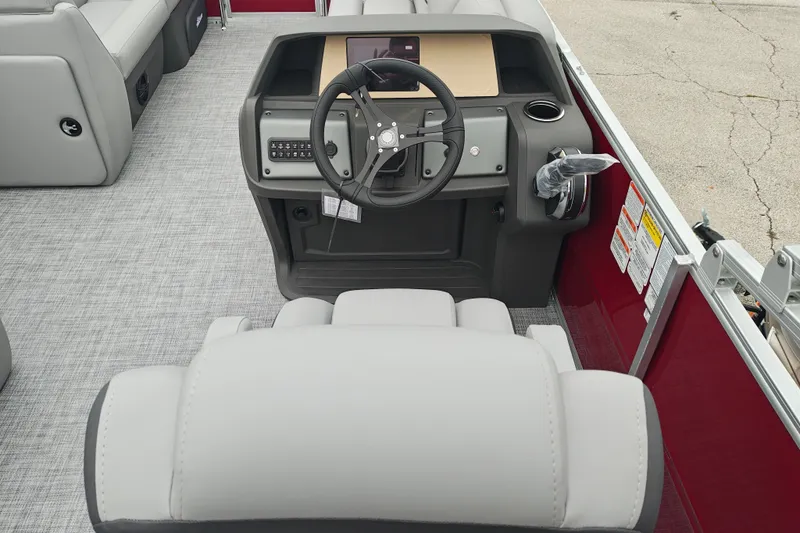 Slide: The Image of 2026 Sun Tracker Party Barge 20 DLX boat interior with steering console and seating. - 20