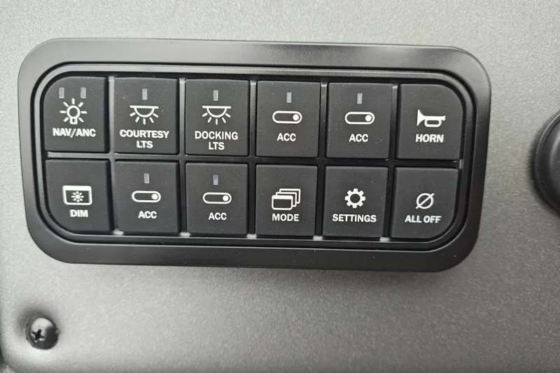 Slide: The Image of Control panel of 2026 Sun Tracker Party Barge 20 DLX with various switches and buttons. - 21