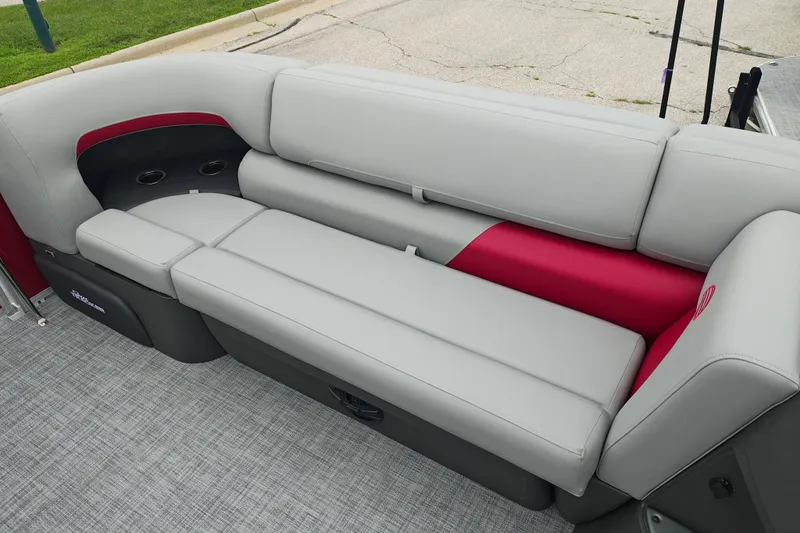 Slide: The Image of 2026 Sun Tracker Party Barge 20 DLX interior seating with gray and red upholstery. - 24