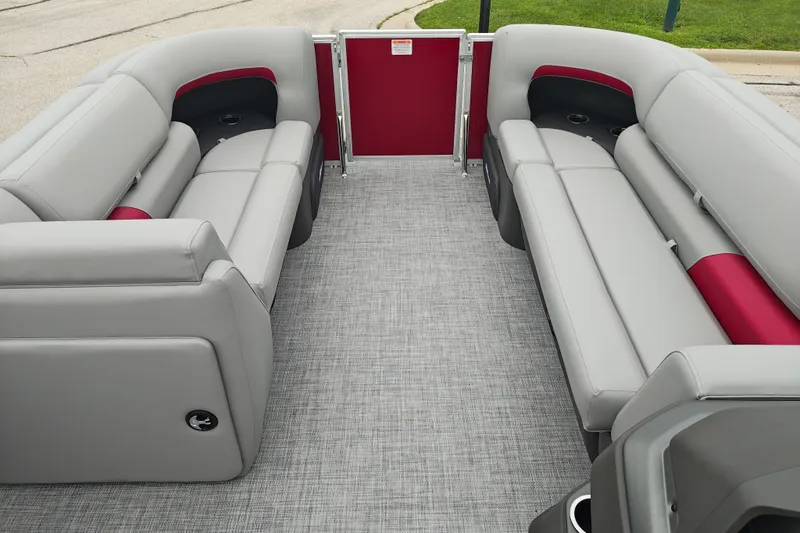 Slide: The Image of 2026 Sun Tracker Party Barge 20 DLX interior with gray and red seating, spacious layout. - 22