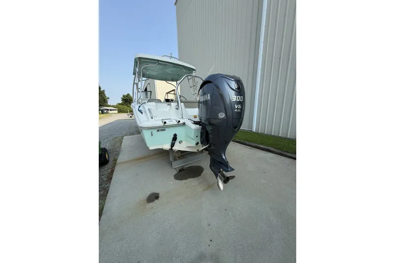 Slide: The Image of 2023 Key West 239 DFS boat with Yamaha 300 V6 engine, parked outdoors. - 5