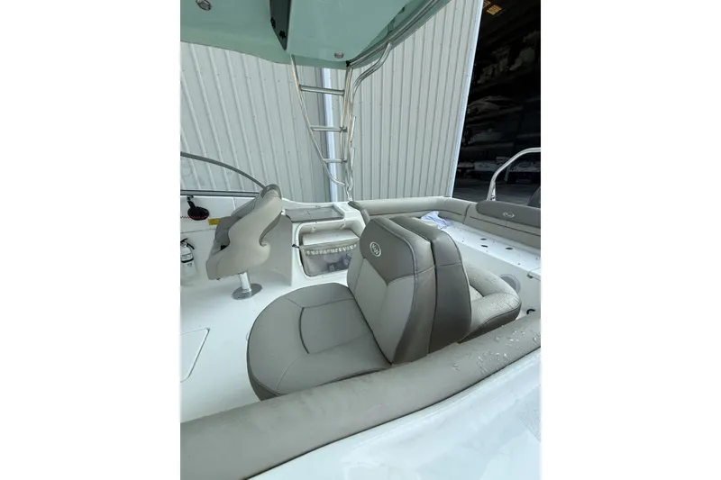 Slide: The Image of 2023 Key West 239 DFS boat interior with cushioned seating and helm station. - 3