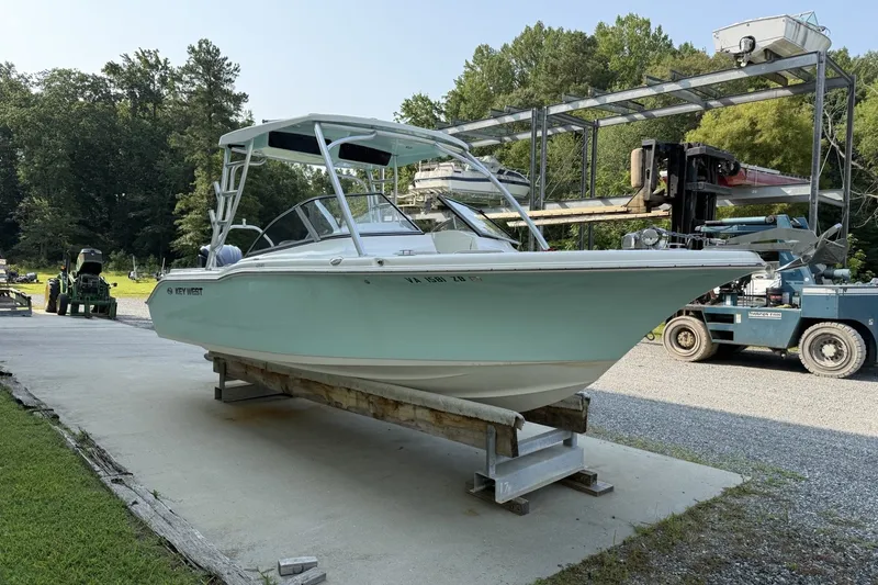 The Image of 2023 Key West 239 DFS boat on display at a marina with trees in background. - 1