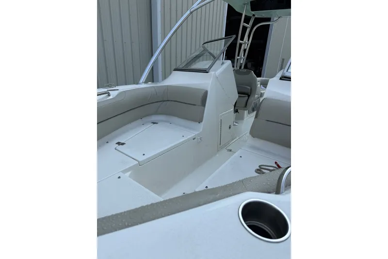 Slide: The Image of 2023 Key West 239 DFS boat interior with seating and storage compartments. - 2