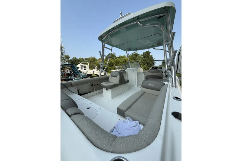 Slide: The Image of 2023 Key West 239 DFS boat interior with seating and canopy, docked outdoors. - 6