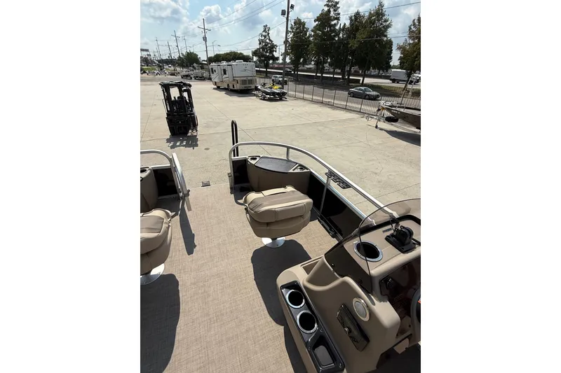 Slide: The Image of 2022 Sun Tracker Bass Buggy 18 DLX pontoon boat interior with seating and console. - 15