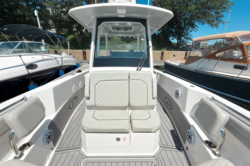 Slide: The Image of 2022 Pursuit S 288 Sport boat interior with cushioned seating and sleek design. - 14