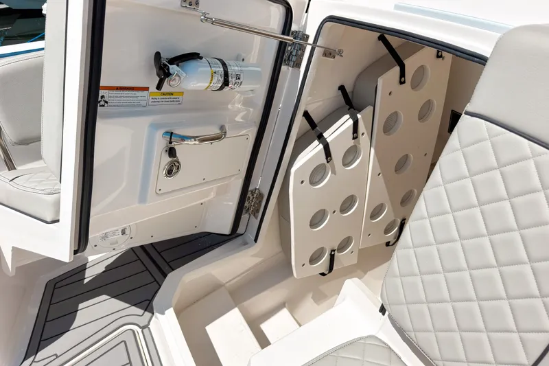 Slide: The Image of 2022 Pursuit S 288 Sport boat interior with storage and fire extinguisher. - 19