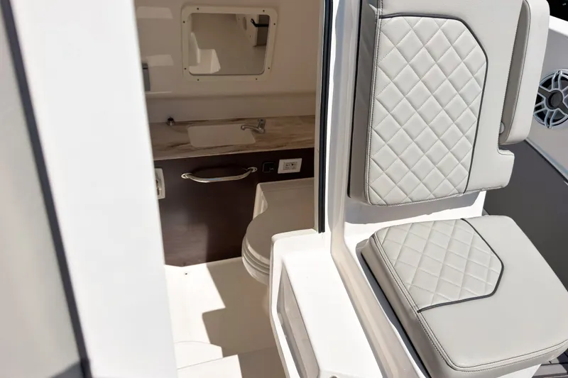 Slide: The Image of 2022 Pursuit S 288 Sport boat interior with seating and compact sink area. - 20