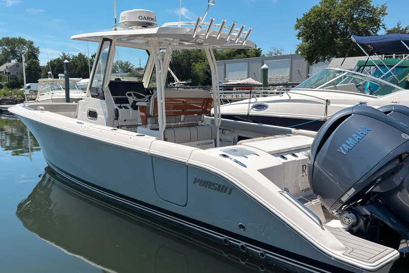 The Image of 2022 Pursuit S 288 Sport boat docked with Yamaha engines, featuring sleek design. - 0
