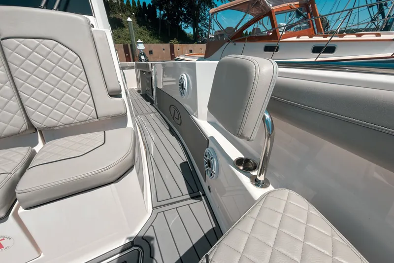 Slide: The Image of 2022 Pursuit S 288 Sport boat interior with quilted seating and sleek design. - 16
