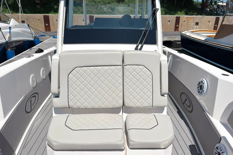 Slide: The Image of 2022 Pursuit S 288 Sport boat with cushioned seating and sleek design. - 13