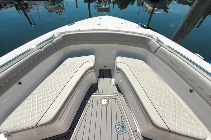 Slide: The Image of Luxurious seating area on 2022 Pursuit S 288 Sport boat, docked by calm waters. - 15