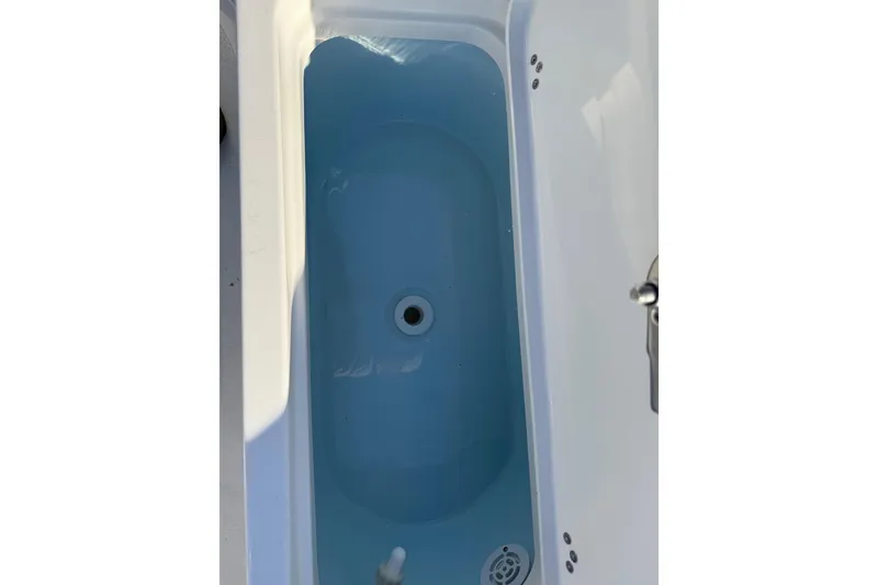 Slide: The Image of Livewell in 2026 Key West 188 Bay Reef boat, featuring a clean, blue interior. - 11
