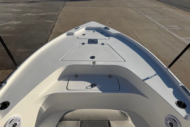Slide: The Image of 2026 Key West 188 Bay Reef boat deck, featuring storage compartments and seating. - 9