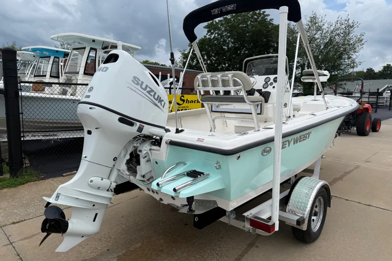 Slide: The Image of 2027 Key West 188 Bay Reef boat with Suzuki outboard motor on trailer. - 2