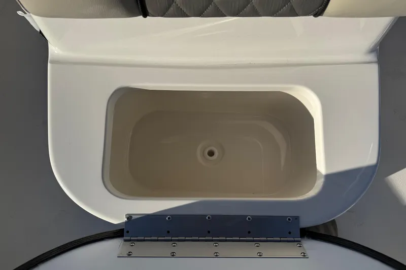 Slide: The Image of 2026 Key West 188 Bay Reef boat storage compartment with open lid, showcasing interior space. - 12