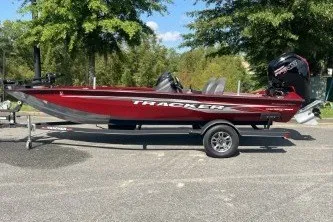 The Image of 2021 Tracker Pro Team 190 TX Tournament Edition boat on trailer, parked outdoors. - 0