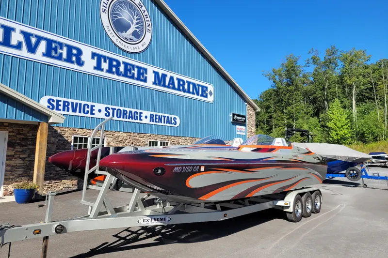 Slide: The Image of 2015 Cobra 260 Venom boat on trailer at Silver Tree Marine, sunny day. - 2