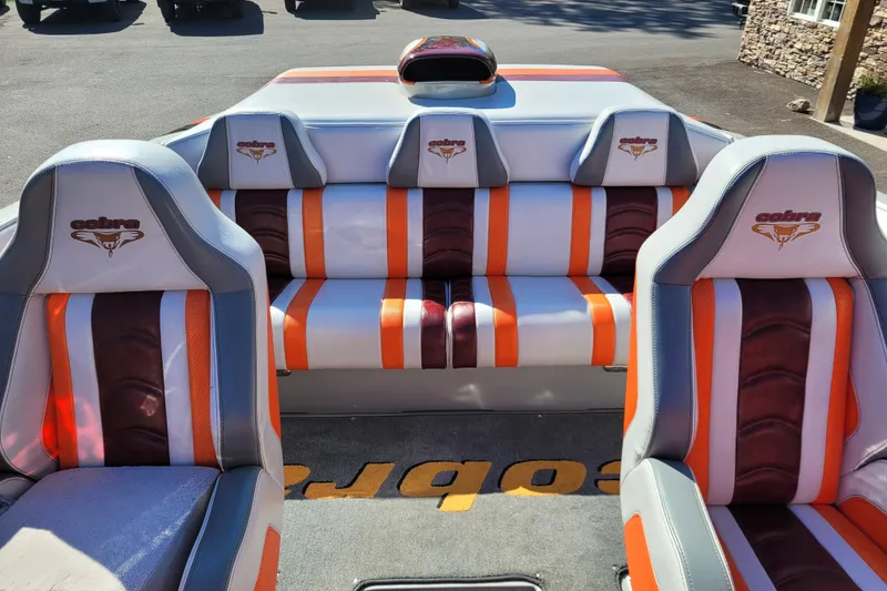 Slide: The Image of 2015 Cobra 260 Venom boat interior with orange and white leather seats. - 12