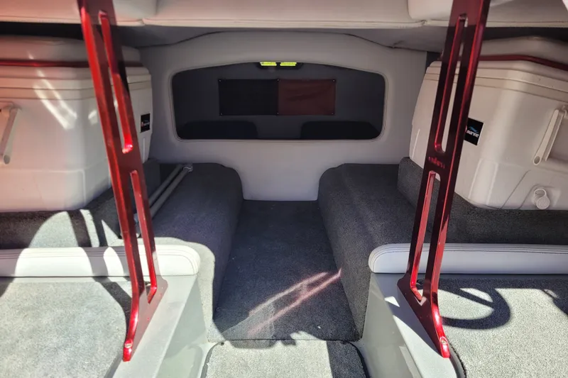Slide: The Image of Interior of a 2015 Cobra 260 Venom boat with red accents and storage compartments. - 11