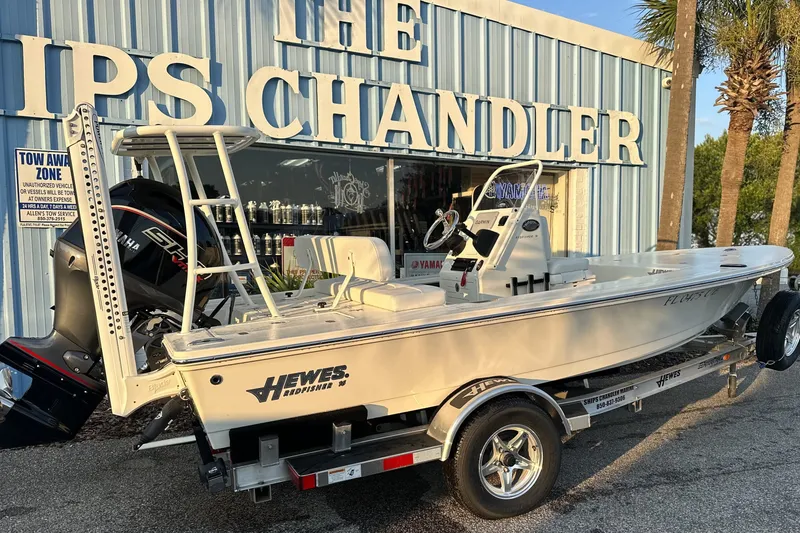 The Image of 2026 Hewes Redfisher 16 boat on trailer outside a marine store. - 0