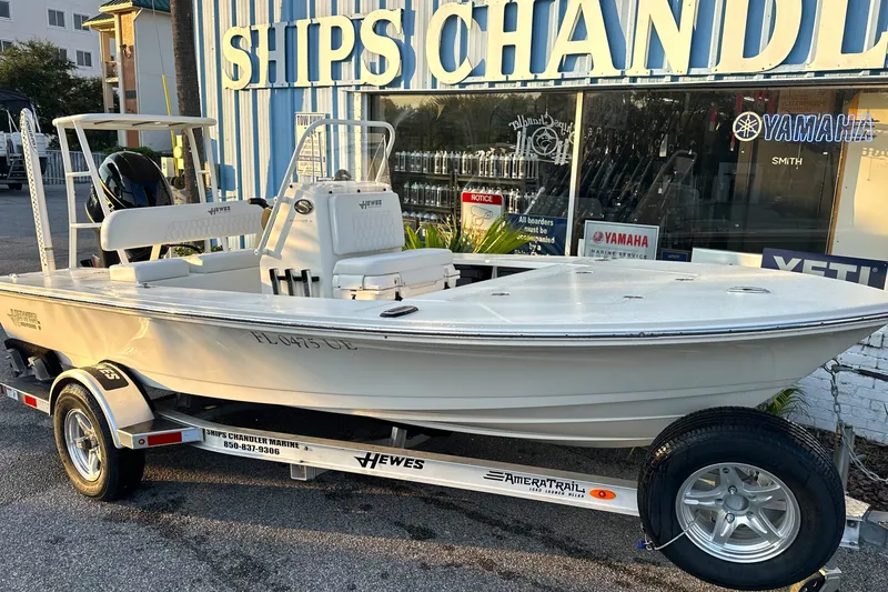 Slide: The Image of 2026 Hewes Redfisher 16 boat on trailer outside Ships Chandler store. - 1