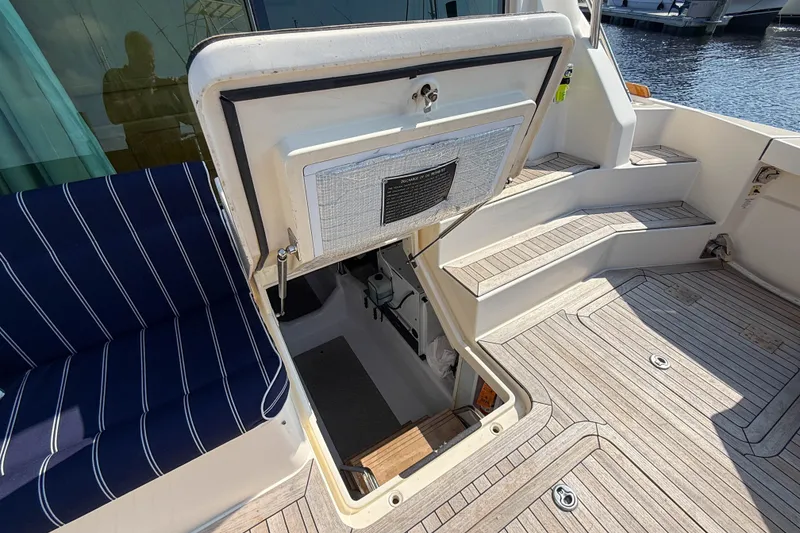 Slide: The Image of Open hatch on 2007 Sabre 52 Salon Express yacht, revealing interior access and striped seating. - 55