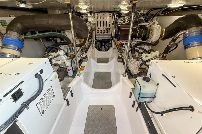 Slide: The Image of Engine room of a 2007 Sabre 52 Salon Express yacht, showcasing mechanical components. - 56