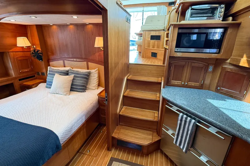 Slide: The Image of Luxurious 2007 Sabre 52 Salon Express interior with cozy bedroom and modern kitchen amenities. - 30