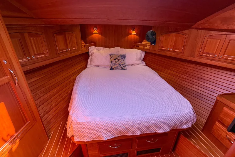 Slide: The Image of Cozy cabin interior of 2007 Sabre 52 Salon Express with wooden paneling and bed. - 39