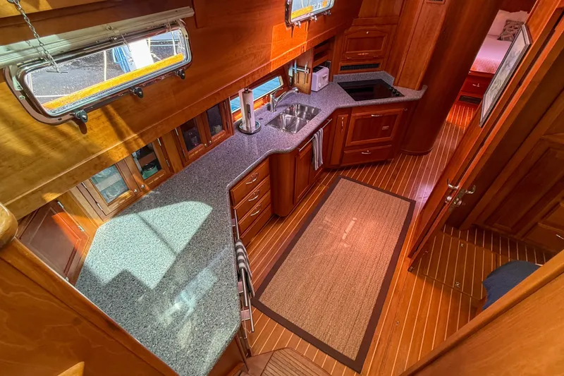 Slide: The Image of Luxurious 2007 Sabre 52 Salon Express yacht interior with elegant wood cabinetry and modern kitchen. - 24