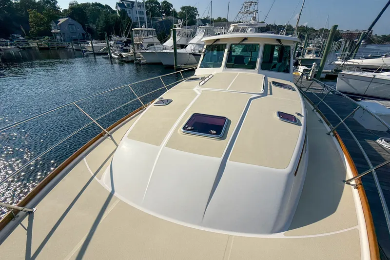 Slide: The Image of 2007 Sabre 52 Salon Express yacht docked at marina, showcasing sleek deck design. - 51