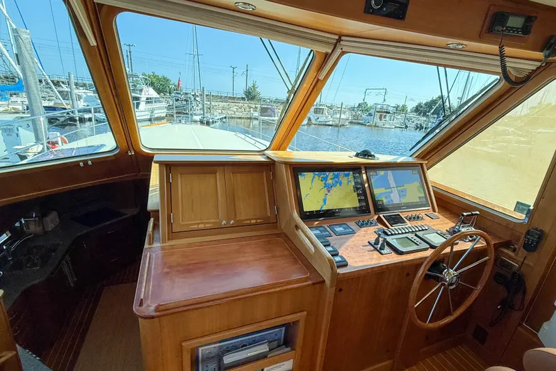 Slide: The Image of 2007 Sabre 52 Salon Express helm with navigation screens and wooden steering wheel. - 20